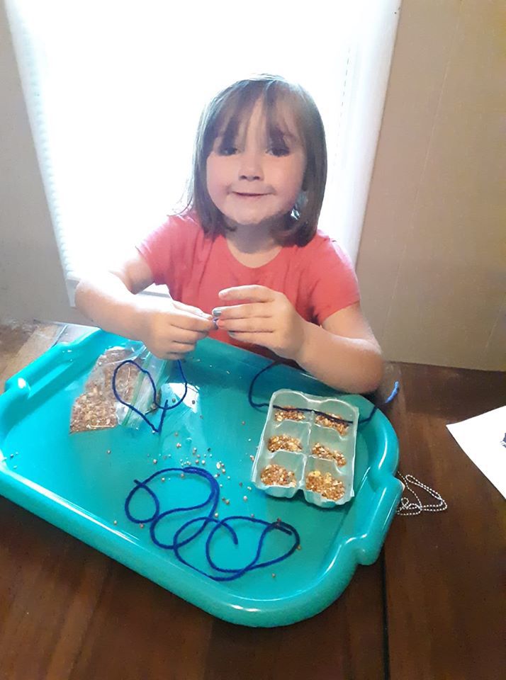 Gracie and her bird feeder